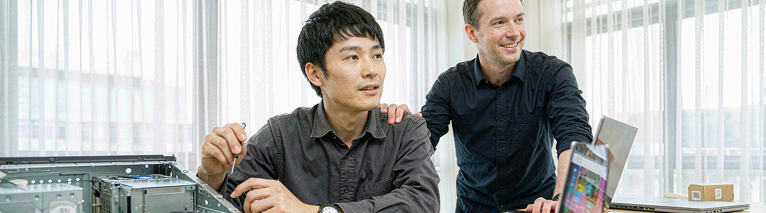 Two engineers reviewing a dashboard together